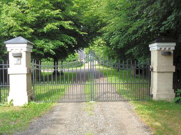 A grand entrance and leafy driveway
