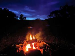 Resplandor de hoguera bajo el cielo nocturno